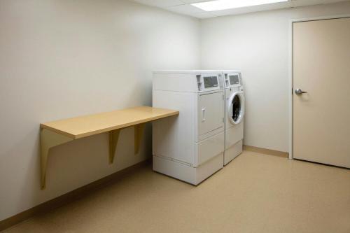 a laundry room with a washing machine and a counter at Fairfield Inn & Suites by Marriott Geneva Finger Lakes in Geneva