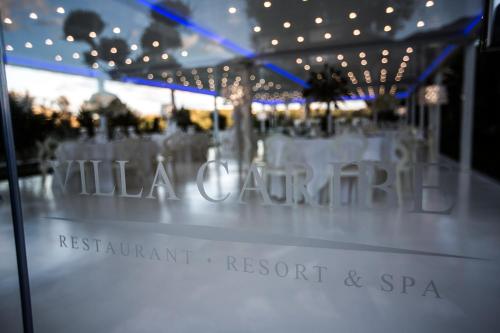 a table set up for a wedding with lights at Villa Caribe Resort & Spa in Spigno Saturnia
