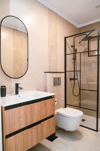 a bathroom with a sink and a toilet and a mirror at Doña Carmen 1 in Las Playitas