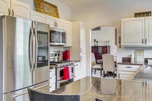 a kitchen with white cabinets and a refrigerator at Spacious Yard and Deck Home 8 Mi to Puget Sound! in Getchell