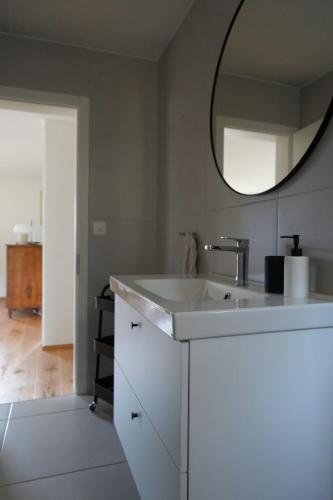 a bathroom with a white sink and a mirror at Castanea VIVA in Breiten
