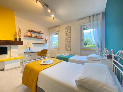 a hospital room with two beds and a fireplace at Olympic Clua' House in Porto Ceresio