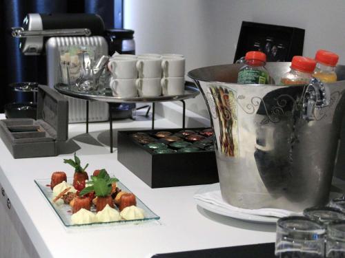 a counter with a mixer and a plate of food at Pullman Bordeaux Lac in Bordeaux