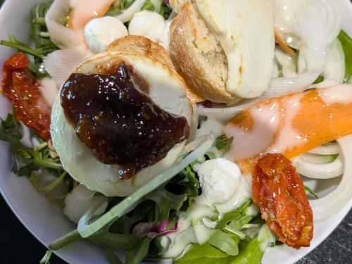a white bowl filled with a salad with meat and vegetables at Hotel ibis Narbonne in Narbonne