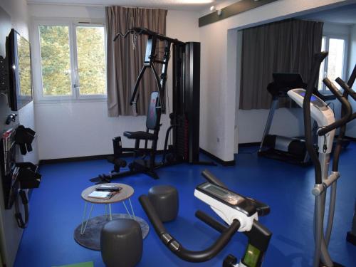 a gym with a blue floor and tread machines at ibis Chartres Ouest Luce in Chartres