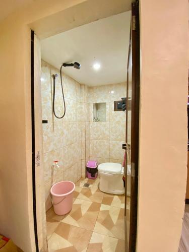 a bathroom with a shower and a toilet at Loft house @ Patar beach in Bolinao