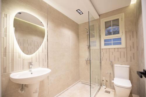 a bathroom with a sink and a toilet and a mirror at Host Prime Villas in Cairo