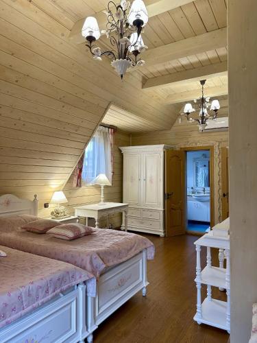 a bedroom with a large bed and two tables at Видовий !!! in Palyanytsya