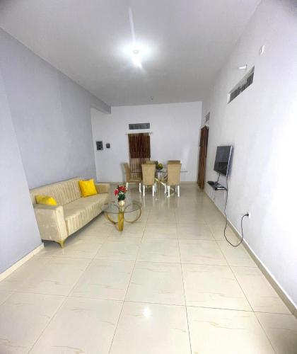 a living room with a couch and a table at Couzy entire home 20 min from international Airport in Luanda