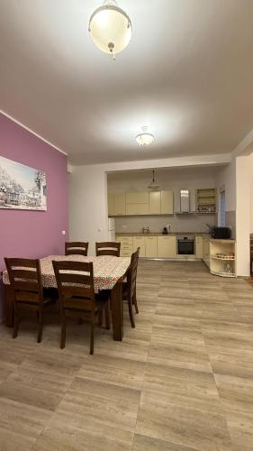 a dining room with a table and chairs and a kitchen at Villa Nadia in Bar