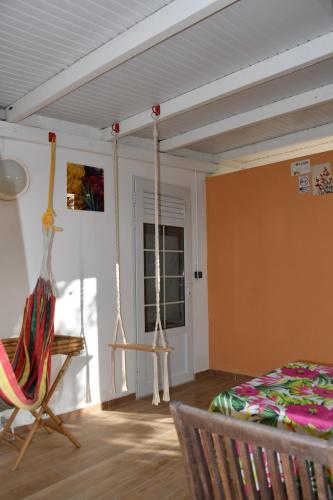 a room with a hammock and a bed in it at O Logis du Morne Jacob "CERISE", Le Morne-Rouge Martinique in Le Morne Rouge