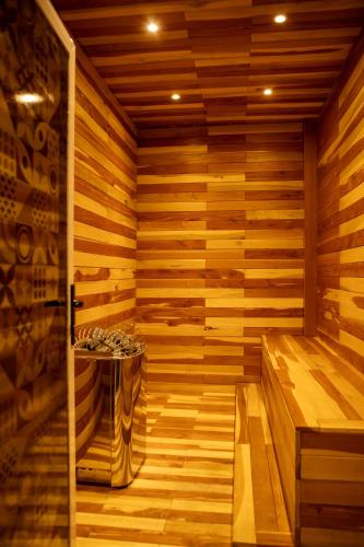 a wooden sauna with a small table in it at Hotel Hacienda Aguacaliente in Tijuana