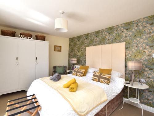 a bedroom with a large bed with yellow pillows on it at 1 Bed in Richmond 36769 in Reeth
