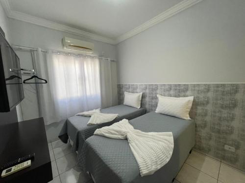 เตียงในห้องที่ Flat Centro 301