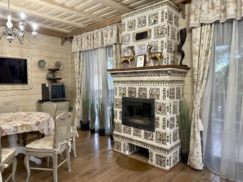 Una chimenea en una habitación con mesa y comedor en Видовий !!!, en Palyanytsya
