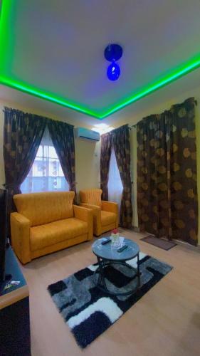 a living room with a couch and a table at Rapid Roost Apartments in Umuahia