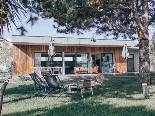 a house with a table and chairs in the yard at ibis Aix en Provence in Aix-en-Provence