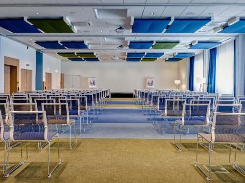 a room with rows of chairs in a hall at Novotel Lyon Gerland Musée des Confluences in Lyon