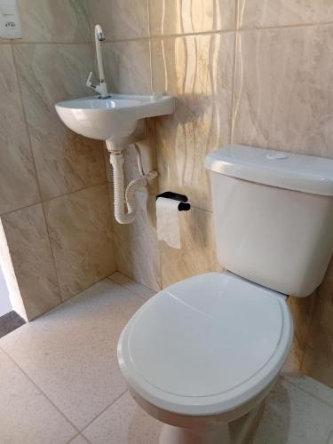 a bathroom with a white toilet and a sink at Pousada Araújo em Paraty in Paraty