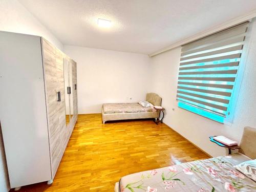 a room with two beds and a window in it at Ideal for families or friends in Prizren