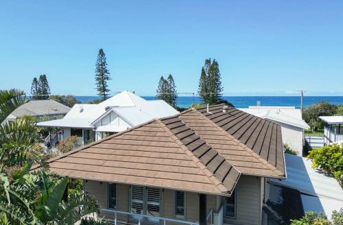 a roof of a house with the ocean in the background at La Luna - Oceanstays in Lennox Head