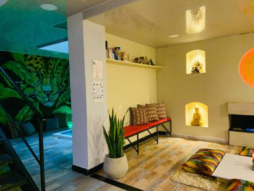 a living room with a bench and a plant at Las Aguas Inner Experience in Bogotá