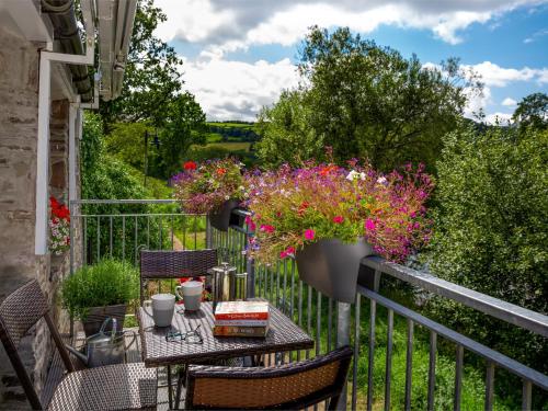 a balcony with a table with flowers on it at 2 Bed in Brecon Town BN140 in Brecon