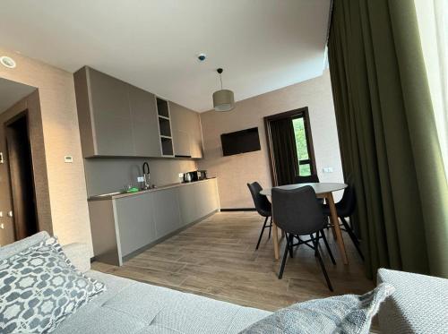a room with a kitchen and a table and chairs at Villa Sunlight in Gonio