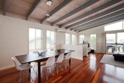 a dining room with a table and chairs at Beach holiday in Tomakin