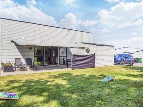 a building with a lawn in front of it at 6 person holiday home in Nexø-By Traum in Neksø