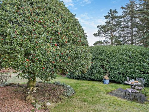 a tree with apples on it next to a table at 1 Bed in Dunning CA333 in Dunning