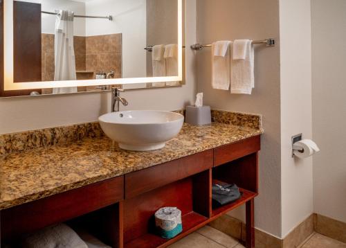 a bathroom with a sink and a mirror at Holiday Inn Express & Suites Cross Lanes by IHG in Cross Lanes