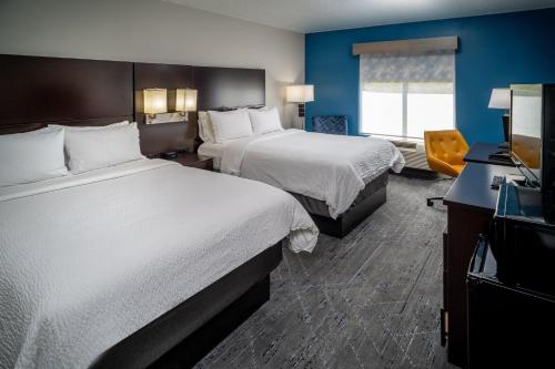 a hotel room with two beds and a television at Holiday Inn Express & Suites Cross Lanes by IHG in Cross Lanes