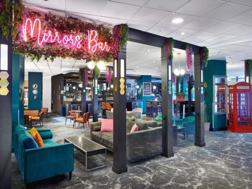 a store with couches and a sign that reads mr surprises box at Novotel London West in London