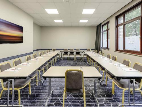 a classroom with rows of tables and chairs at ibis Bremen City in Bremen