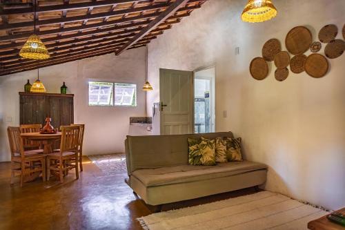 a living room with a couch and a table at POUSADA CARMELITHA in Trancoso