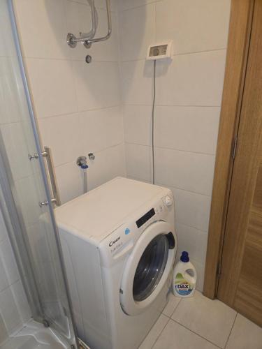 a small bathroom with a washing machine in it at City kvart Grand apartment in Podgorica