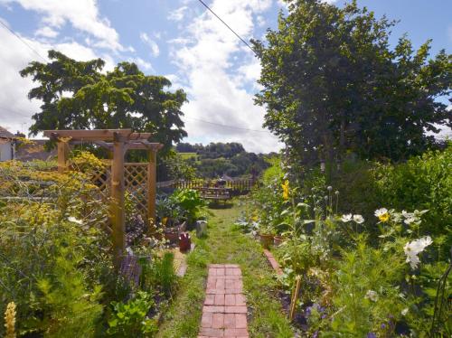a garden with a brick path in the middle of it at 2 bed property in Exeter 79431 in Sandford