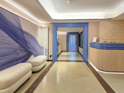 a corridor with a lobby with blue walls at Crowne Plaza Bangkok Lumpini Park by IHG in Bangkok