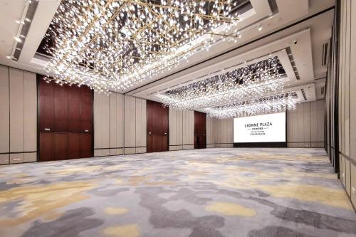 a large ballroom with a stage and chandeliers at Crowne Plaza Shenzhen Nanshan by IHG in Shenzhen