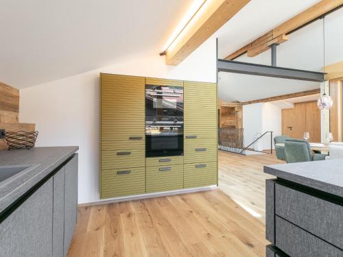 a kitchen with a yellow cabinet in the middle at Hopfgarten Alpin Living Top 5 in Hopfgarten im Brixental