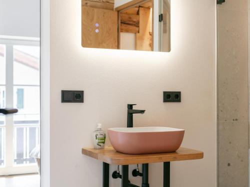 a bathroom with a sink and a mirror on a wall at Hopfgarten Alpin Living Top 5 in Hopfgarten im Brixental