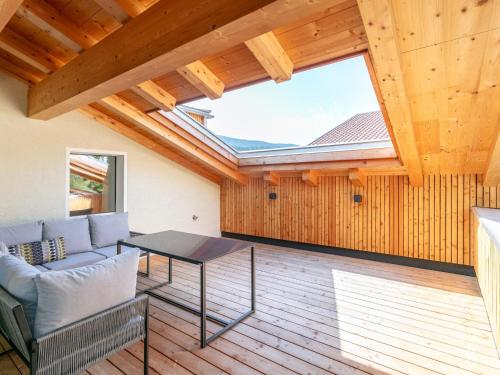 a living room with a table and a large window at Hopfgarten Alpin Living Top 5 in Hopfgarten im Brixental