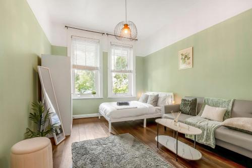 a living room with a couch and a table at Modern 2BR Flat-Terrace-Free Parking-Rail Station in Croydon