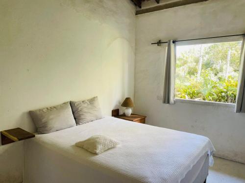 Una cama o camas en una habitación de Casa Manu Trancoso Bahia Brasil