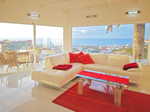 a living room with a couch and a table at Modern Panoramic Villa with Pool & Terrace in Puerto de la Cruz