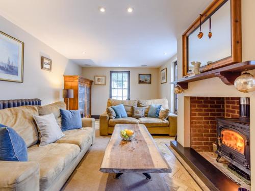 a living room with a couch and a fireplace at 3 Bed in Faversham 78880 in Faversham