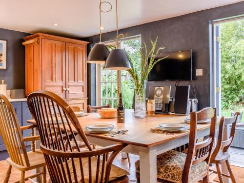 a dining room with a wooden table and chairs at 3 Bed in Faversham 78880 in Faversham