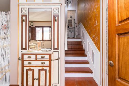a hallway with a staircase with a large mirror at La Casita del Picu en Cabezón de la Sal in Cabezón de la Sal