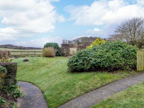 a grassy yard with a fence and a path at 2 Bed in Kelling NCC25 in Kelling